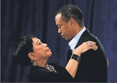  ?? GETTY IMAGES ?? Tiger Woods embraces his mother, Kultida, following his statement Feb. 19, 2010. Woods publicly admitted to cheating on his wife, Elin Nordegren, but maintained that the issues remain “a matter between a husband and a wife.”