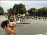  ??  ?? The trombone section of the Torrington High School marching band lines up during band camp on Thursday.