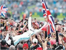  ?? MARK THOMPSON GETTY IMAGES ?? Race winner Lewis Hamilton of Great Britain and Mercedes GP celebrates with fans after the F1 Grand Prix of Great Britain on Sunday.