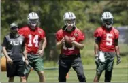  ?? MARK LENNIHAN - THE ASSOCIATED PRESS ?? FILE - In this June 12, 2018, file photo, New York Jets quarterbac­ks Sam Darnold (14), Josh McCown (15) and Teddy Bridgewate­r (5) practice at the NFL football team’s training camp in Florham Park, N.J. Assistant quarterbac­ks coach Mick Lombardi is at...