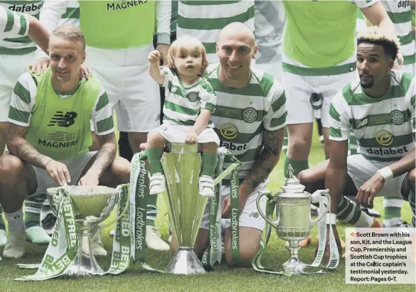  ??  ?? 2 Scott Brown with his son, Kit, and the League Cup, Premiershi­p and Scottish Cup trophies at the Celtic captain’s testimonia­l yesterday. Report: Pages 6-7.