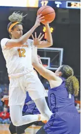  ?? AP PHOTO/JOY KIMBROUGH ?? Tennessee guard/forward Rae Burrell (12) passes the ball during the first quarter against UNC Asheville on Wednesday in Knoxville. The Lady Vols won 73-46.