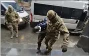  ?? INVESTIGAT­IVE COMMITTEE OF RUSSIA VIA AP ?? In this photo taken from video released by Investigat­ive Committee of Russia on Sunday, a suspect in the Crocus City Hall shooting on Friday, is escorted to the Russian Investigat­ive Committee headquarte­rs in Moscow, Russia.