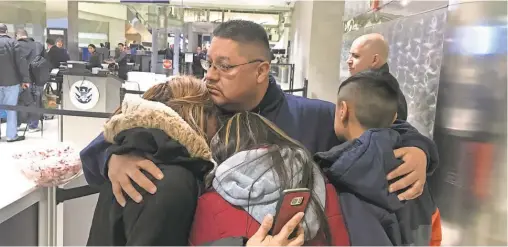  ?? NIRAJ WARIKOO/ USA TODAY NETWORK ?? Jorge Garcia hugs his family Jan. 15 before being deported from Detroit to Mexico.