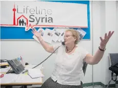  ?? CHRIS YOUNG/THE CANADIAN PRESS ?? A volunteer at Lifeline Syria takes a call regarding sponsorshi­p at the organizati­on’s offices in Toronto on Friday. The organizati­on is trying to resettle 1,000 refugees in the Greater Toronto Area.