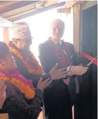  ?? Keith FLaycock cuts the ribbon at the official opening of one of the school libraries in Nepal ??