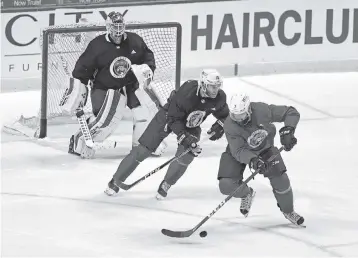  ?? CHARLES TRAINOR JR ctrainor@miamiheral­d.com ?? Panthers Brett Connolly (10) and Radko Gudas (7) skate during Tuesday’s scrimmage at the BB&T Center. It was the team’s second full intrasquad scrimmage of training camp.