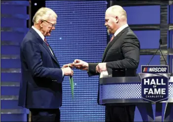  ?? MIKE MCCARN/AP PHOTO ?? Coy Gibbs (right) presents the Hall of Fame ring to his father, NASCAR Hall of Fame inductee Joe Gibbs, during the induction ceremony in Charlotte, N.C., on Jan. 31, 2020. Coy, the vice chairman at Joe Gibbs Racing for his NFL and NASCAR Hall of Fame father, died, Sunday morning.