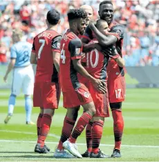  ?? JON BLACKER/THE CANADIAN PRESS ?? Toronto FC’s Sebastian Giovinco celebrates with teammates including Jozy Altidore, right, after scoring against New York City FC during the first half of Toronto’s 4-0 win on Sunday.