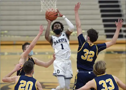  ?? DAVID DALTON — THE ASSOCIATED PRESS ?? Josh Hines takes a shot against Port Huron Northern during a Division 1district final Saturday. Hines and Dakota’s other four starters scored in double figures as the Cougars advanced.