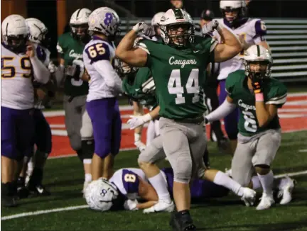  ?? DAVID C. TURBEN — FOR THE NEWS-HERALD ?? Lake Catholic linebacker Simon Taraska celebrates after a stop on fourth down from the Cougars’ 5-yard line that helped seal the victory over Bloom-Carroll on Nov. 14.