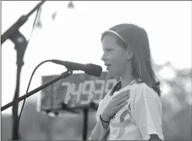  ?? NWA Democrat-Gazette/BEN GOFF • @NWABENGOFF ?? Audrey Shellhamme­r, 11, a student at The New School in Fayettevil­le, leads the Pledge of Allegiance.