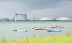  ??  ?? Boats float in front of the VOPAK oil storage terminal in Johor, Malaysia. Oil prices tumbled more than one per cent yesterday in Asia, extending the previous day’s sharp falls after the Internatio­nal Energy Agency warned of weakening demand. — Reuters...