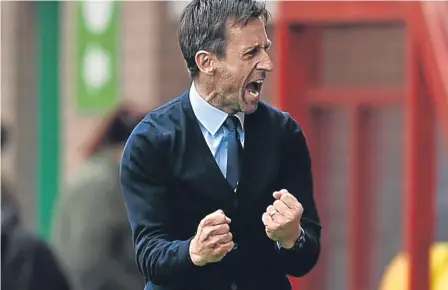  ??  ?? Dundee interim manager Neil McCann celebrates his side scoring at Fir Park as he won his first match in charge.