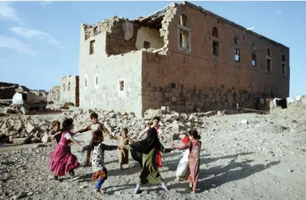  ?? | Reuters ?? CHILDREN play near a house destroyed in air strike carried out by the Saudi-led coalition in Faj Attan village, Sanaa, Yemen, yesterday.