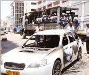  ??  ?? This picture collage shows the now deceased armed with bricks at the height of the argument, police officers carrying out investigat­ions after the shooting, the man’s lifeless body and the suspected shooter’s vehicle after it was torched by an angry mob