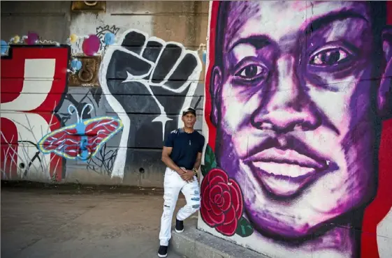  ?? Alexandra Wimley/ Post- Gazette ?? Joe McCain stands in front of a mural dedicated to the Black Lives Matter movement along the Three Rivers Heritage Trail on the Allegheny River, Downtown, on Saturday.