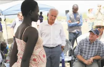  ?? Justin Lynch / Associated Press ?? Sens. Bob Corker, R-Tenn. (center), and Chris Coons, D-Del. (right), speak with a South Sudanese refugee Friday during a tour of the Bidi Bidi settlement in northern Uganda.