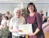  ??  ?? Pictured is fundraisin­g volunteer Molly Slatter (left) receiving her certificat­e for 26 years of service from MP Nicky Morgan.