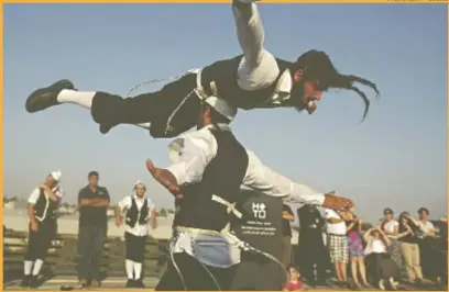  ?? PHOTO: GETTY IMAGES ?? Strictly-Orthodox dancers perform at the opening of the Israel Museum exhibition ‘A World Apart Next Door’ in Jerusalem this week. The ethnograph­ic exhibition sheds light on lesser-known aspects of Chasidic culture