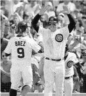  ?? JOHN J. KIM/TNS ?? Cubs 1B Anthony Rizzo, right, walked 3 times but none was bigger than his bases-loaded walk that broke a 2-2 tie.