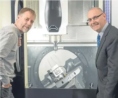  ?? Picture: Chris Watt Photograph­y. ?? Sterling Precision Engineerin­g Services MD John Mitchell and Charles Davidson from Bank of Scotland inspect the milling machine in the Kirkcaldy premises.