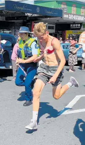  ?? ?? Police join in the Undie 500 relay at Waihi’s Warm Up Party.