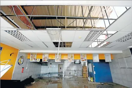  ?? Picture: MARK ANDREWS ?? DESTROYED: Extensive damage was caused to shops at Mdantsane Mall yesterday, including the Fish & Chip Co, after a hail-storm passed through the area