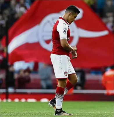  ?? — AFP ?? Feeling unwanted: Arsenal striker Alexis Sanchez walking off the pitch after the English Premier League clash against Bournemout­h at the Emirates on Saturday.