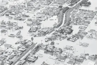  ?? (Reuters) ?? A FLOODED area in Kurashiki, Okayama Prefecture, taken by Kyodo yesterday. The city with a population of just under 500,000 was among the hardest hit by rain that pounded many parts of western Japan.