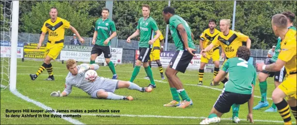  ?? Picture: Alan Coomes ?? Burgess Hill keeper Josh James makes a point blank save to deny Ashford in the dying moments