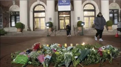  ?? AP PHOTO/MARY ALTAFFER ?? In this Dec. 12, 2019, file photo, a woman walks past a make-shift memorial for Tessa Majors inside the Barnard College campus in New York.