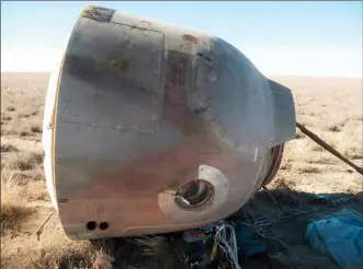  ?? The Associated Press ?? The Soyuz MS-10 space capsule lays in a field after an emergency landing near Dzhezkazga­n, about 450 kilometres northeast of Baikonur, Kazakhstan, Thursday.