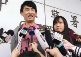  ??  ?? Disqualifi­ed lawmakers Baggio and Yau meet journalist­s outside a police station in Hong Kong on Wednesday.