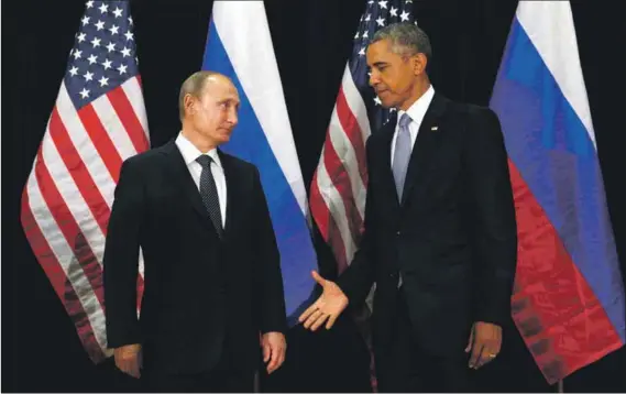  ?? Photo: Kevin Lamarque/Reuters ?? Take five: Barack Obama and Vladimir Putin prepare to shake hands at the United Nations in New York this week.