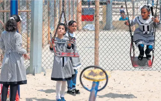  ?? AFP ?? Palestinia­n school girls play at a UN Relief and Works Agency’s school in the Rafah refugee camp, southern Gaza Strip, on Saturday. —