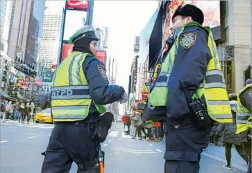  ?? Kena Betancur AFP/Getty Images ?? IN NEW YORK CITY, authoritie­s will station sanitation trucks filled with sand at key intersecti­ons to stop any attack using a truck on New Year’s Eve. Cities nationwide are taking similar precaution­s.