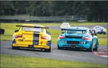  ?? COURTESY PHOTO ?? Tim Holt, driving the yellow Porsche, races to win and so does his son, Tim Holt Jr. The Holt father- and- son are next racing at events in Sebring, Watkins Glen, Ohio, and Georgia in 2021.