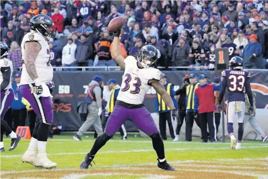  ?? Associated Press DAVID BANKS/AP PHOTOS ?? Baltimore Ravens running back Devonta Freeman celebrates scoring the game-winning touchdown against the Chicago Bears on Sunday.