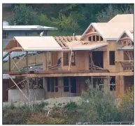  ?? (AP) ?? Builders work on a new house in October on the waterfront in Gig Harbor, Wash. The fourth-quarter decline in U.S. productivi­ty was the largest in nearly four decades.