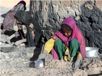  ??  ?? Afghan children collect coal from a brick factory for their home on the outskirts of Kabul. — AFP photo