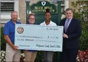  ?? SUBMITTED PHOTO ?? Deputy Chief Adam Berry, left, and Sheriff Sean Killkenny, right, present Deputy Kayla Lochner-Franz and Siani Sanders with Montgomery County Sheriff’s Office scholarshi­p award check.