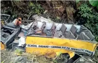  ?? PTI ?? Mangled remains of a school bus that fell into deep gorge at Renuka, in Sirmaur district, on Saturday. —