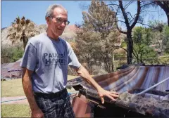  ?? Samie Gebers
/The Signal ?? Dennis Brazzil surveys his charred jacuzzi on Saturday after the Placerita Fire burned parts of his property On Tenderfoot Trail Road.