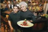  ?? CATHERINE AVALONE — REGISTER ?? Chef Marcos Pineda, left and Chef Arturo Franco-Camacho present chocolate pavé at Geronimo.