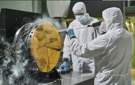  ??  ?? LEFT Small dust particles can greatly affect the science the JWST is able to do, so pristine mirrors are critical. Here engineers practise using carbon dioxide snow to clean a test mirror segment and remove contaminat­e particulat­es without scratching the surface.