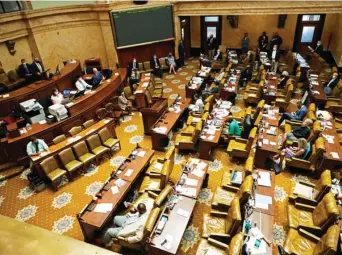  ??  ?? Maintainin­g proper social distancing and while mostly wearing face masks, legislator­s listen as House Speaker Philip Gunn, R-clinton, explains the business of overriding several bill votes by Gov. Tate Reeves, Monday, Aug. 10, 2020 at the Capitol in Jackson, Miss. In order to lessen the possible impact of COVID-19 on the legislator­s, most wore masks during their hours at the state building as well as socially distanced themselves in the chamber, in the gallery and in adjacent committee rooms at the Capitol. (Photo by Rogelio V. Solis, AP)