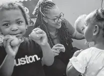  ?? ?? Kondrea Graves, center, leads an activity for her students, ages 18 months to 23 months, on Oct. 26 at Cradles 2 Crayons Early
Learning Academy in Houston.