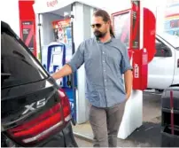  ?? STAFF FILE PHOTO BY TIM BARBER ?? Brandon Guillory, of Walker, La., fills his tank with fuel at the Circle K Exxon on Cummings Highway in 2017. Current gas prices in Chattanoog­a are higher than prices in July of last year.