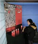  ?? /Reuters ?? Scene of bombing: A woman lights a candle at Atocha train station on the day of a memorial for the March 11 2004 train bombings in Madrid, Spain, on Monday.